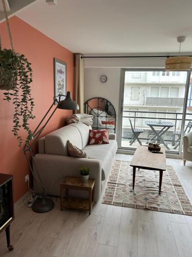 a living room with a couch and a table at Parenthèse d'Opale Hardelot in Neufchâtel-Hardelot