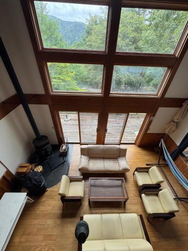 an overhead view of a living room with a large window at Cabin B vacation house rental Mt Fuji View 3 min lake Saiko 5min drive Lake Kawaguchi in Fujikawaguchiko