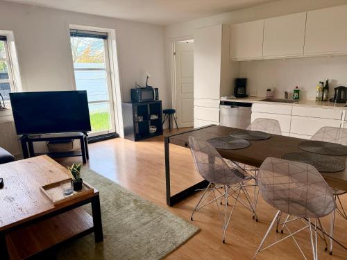 a kitchen with a table and chairs in a room at 2 bedroom apartment near the sea in Tisvildeleje