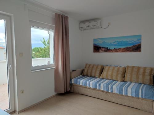a living room with a couch and a window at Villa Ivka - 100 m do plaže uvala Soline - KRK in Malinska