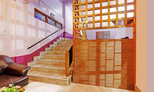 a staircase with a wooden door in a room with stairs at Itsy Hotels Shillong Tower Guesthouse in Shillong