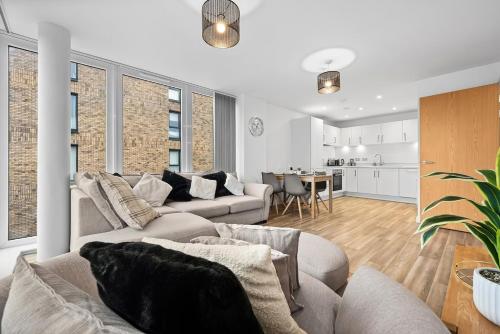 a living room with two couches and a kitchen at The Urban Haven in Birmingham