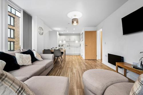 a living room with a couch and a dining room at The Urban Haven in Birmingham