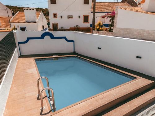 a swimming pool on the roof of a building at Alentejo Poolside By Gt House in São Domingos de Ana Loura