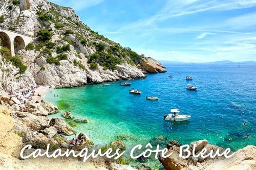 a group of boats in the water on a beach at Cocon jungle bohème 12 min de la mer in Martigues