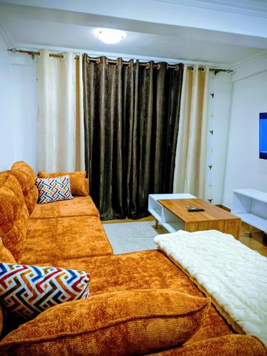 a living room with a couch and a table at Cosmic home in Thika