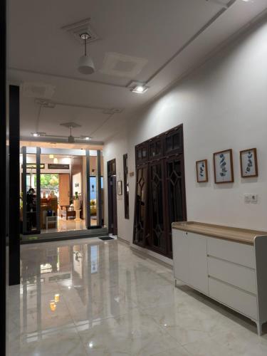 a room with a lobby with a counter and some doors at Kalakoala by Zzz in Malang