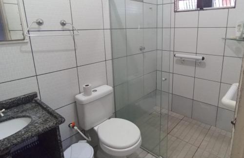 ein Badezimmer mit Toilette und Waschbecken in der Unterkunft casa de praia a 5 minutos da praia central in Marataizes