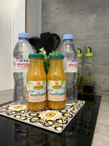 three bottles of evian are sitting on a tray at Studio Cosy - Manoir Securisé - Avon in Avon