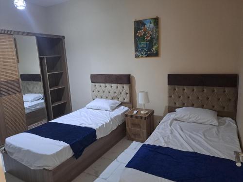 a bedroom with two beds and a mirror at Turtles beach resorts in Hurghada
