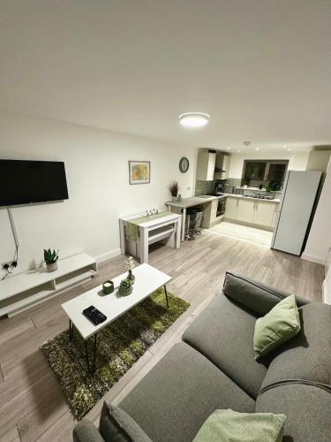 a living room with a couch and a table at Modern Apartment Liverpool in Liverpool
