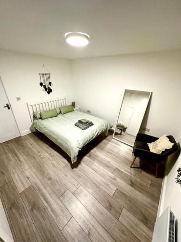 a bedroom with a bed and a chair in it at Modern Apartment Liverpool in Liverpool