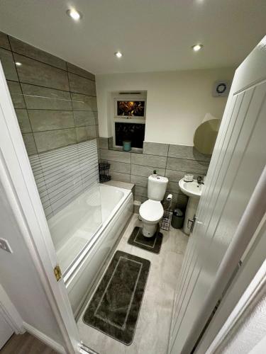 a bathroom with a tub and a toilet and a sink at Modern Apartment Liverpool in Liverpool