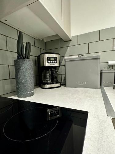a kitchen with a counter top with a coffee maker at Modern Apartment Liverpool in Liverpool