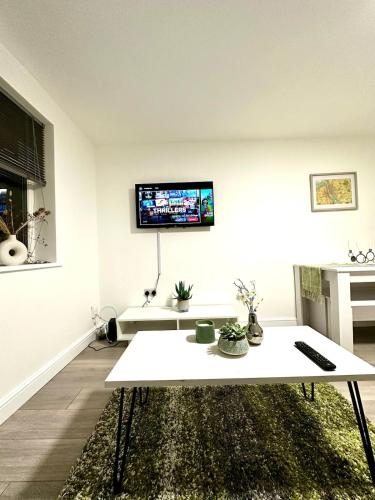 a living room with a tv on the wall at Modern Apartment Liverpool in Liverpool