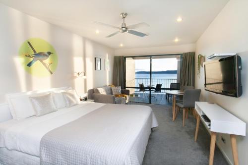 a hotel room with a bed and a living room at Boulevard Waters in Taupo