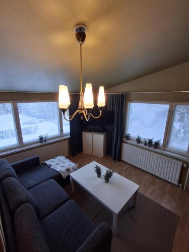 a living room with a couch and a table at Guesthouse Sahanpera in Rovaniemi