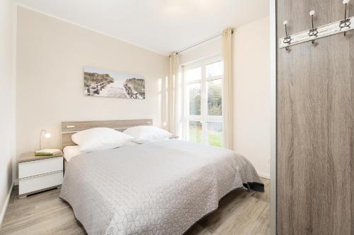 Postel nebo postele na pokoji v ubytování Bürgermeister-Fox 44a An der Waterkant