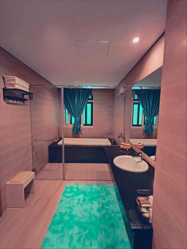a large bathroom with a tub and a sink at SUN House in Phú Quốc