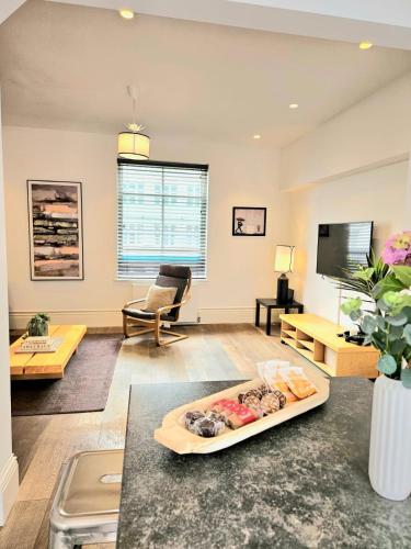 a living room with a tray of food on a table at City Centre 3BR WiFi & Parking For Contractors & Families in Hull