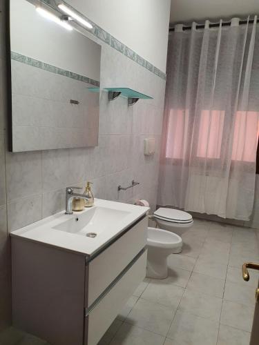 a bathroom with a sink and a toilet at Infinity Karla House 2 in Chioggia