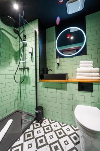 a bathroom with a shower and a sink and a toilet at Duke Street Boutique Hotel in Liverpool