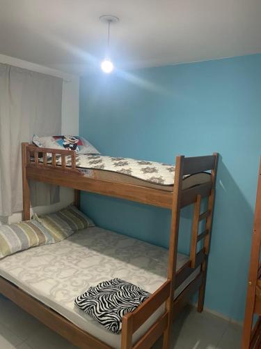 a couple of bunk beds in a room at Apartamento Itapoá in Itapoa