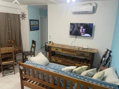 a living room with a piano on the wall at Apartamento Itapoá in Itapoa