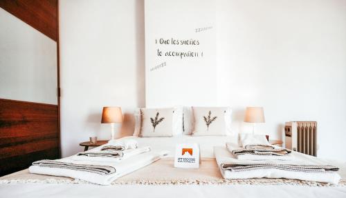 a bed with white sheets and pillows on it at Amadora Terrace View By Gt House in Amadora