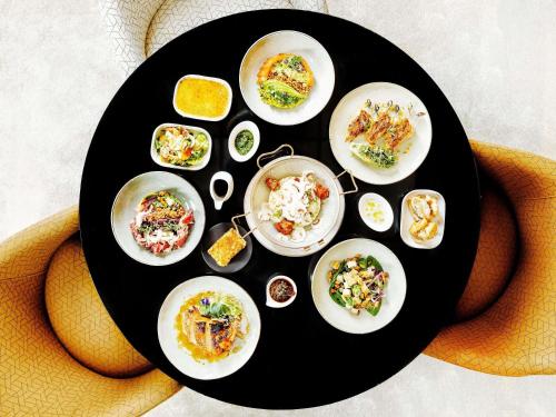 a plate with plates of food on a table at Grand Hotel Bregenz - MGallery Collection in Bregenz