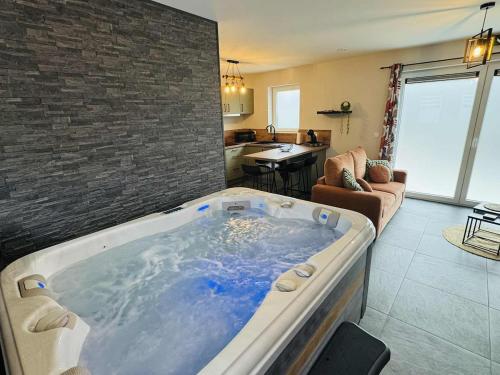 a large jacuzzi tub in a living room at Le cocon de pernelle in Couvin