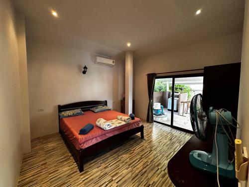 a bedroom with a bed and a fan at 3 bedroom villa with swimming pool Lamai in Nathon Bay