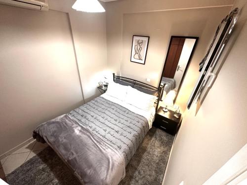 a small bedroom with a bed in a room at Argiro's apartment in Mytilene