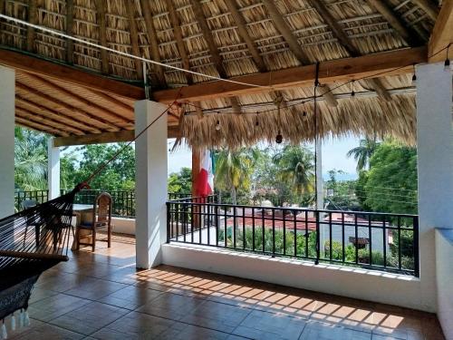 a view from the porch of a house with a balcony at Casa Chikatana un lugar familiar y elegante a pasos de la playa Bacocho in Puerto Escondido