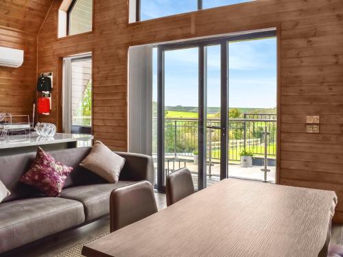 ein Wohnzimmer mit Sofa und Tisch in der Unterkunft Centilen Pedr - Daffodil - Ukc7078 in Mydroilin