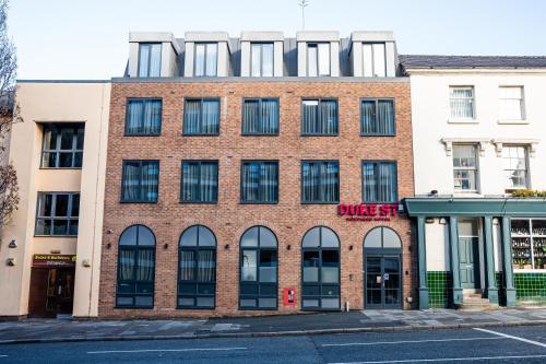a brick building with windows on a street at Duke Street Boutique Hotel in Liverpool