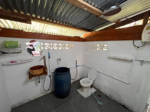 a bathroom with a toilet and a trash can at Balance home happy in Ban Laem Sai
