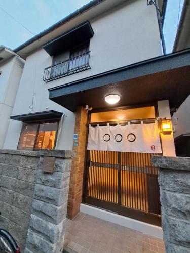 a front door of a house with a gate at Out of Office Hostel by 旅路 in Fukuoka