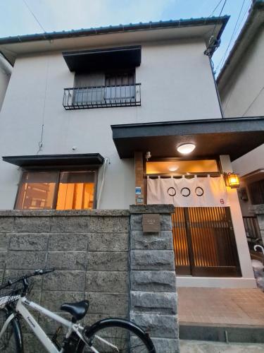 a bike parked in front of a building at Out of Office Hostel by 旅路 in Fukuoka