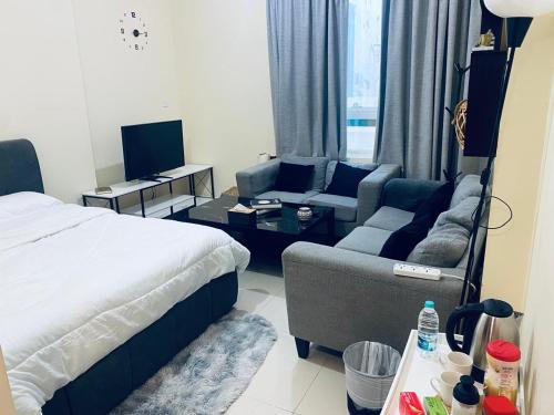 a hotel room with a bed and a living room at Rest House Hostel in Abu Dhabi
