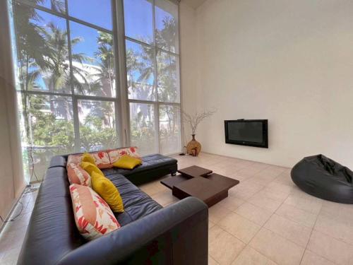 a living room with a blue couch and a tv at Hua Hin Blue Lagoon Island Villa A Family Paradise in Ban Nong Chaeng