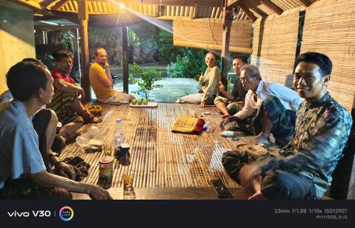 a group of people sitting around a table at Teman Homestay in Kuta Lombok