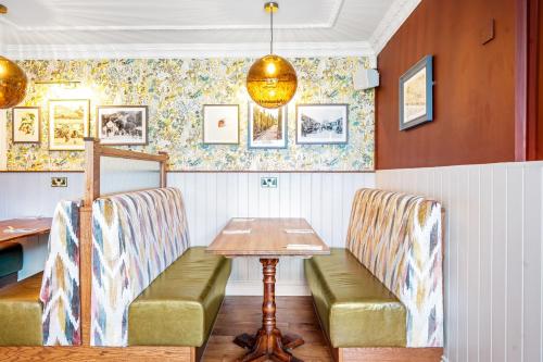 a dining room with two chairs and a table at Sidcot Arms in Winscombe