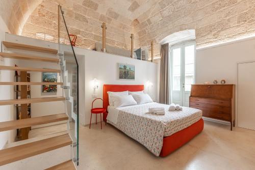 a bedroom with a bed with a red headboard at MandorleOlio in Polignano a Mare