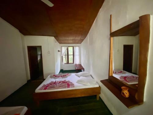 Ένα ή περισσότερα κρεβάτια σε δωμάτιο στο Handunkanda Nature Escape