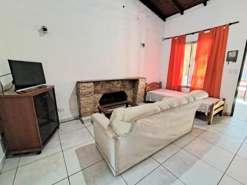 ein Wohnzimmer mit Couch und Kamin in der Unterkunft Casa exclusiva con pile in San Antonio de Arredondo