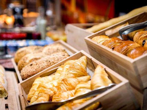 a bunch of different types of breads and pastries at ibis Rodez Centre in Rodez