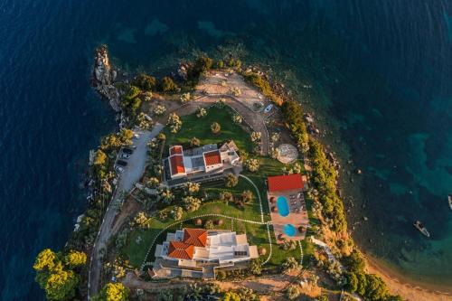 an aerial view of a house on an island in the ocean at Cape Blue Suites in Achladies