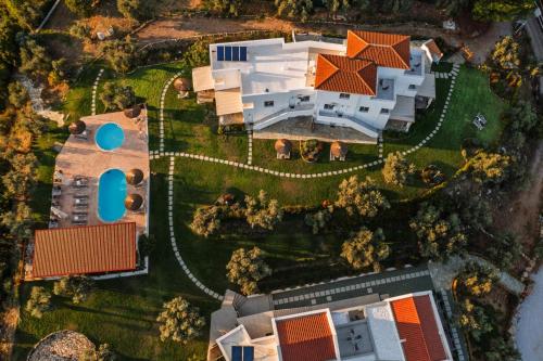 an overhead view of a house with a yard at Cape Blue Suites in Achladies