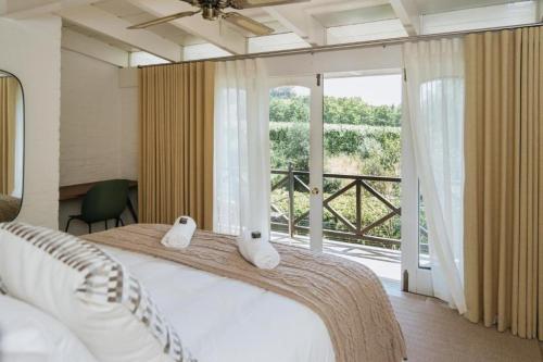 Ένα ή περισσότερα κρεβάτια σε δωμάτιο στο Klein Champagne Guesthouse and Cottages